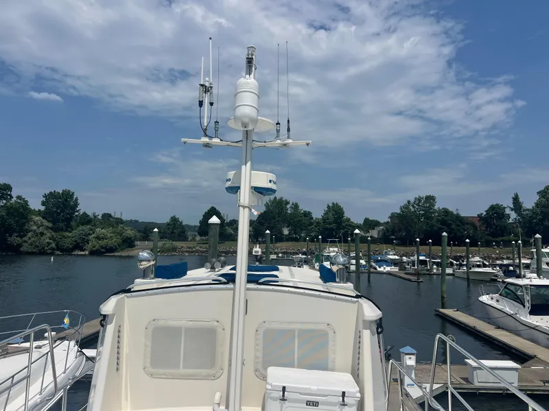 Slide: The Image of Cherubini Independence 1998 yacht docked at marina under partly cloudy sky. - 11