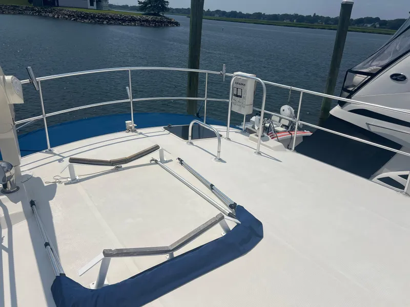 Slide: The Image of Deck of 1998 Cherubini Independence yacht docked by a serene waterfront. - 14