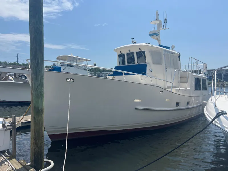 Slide: The Image of Cherubini Independence 1998 yacht docked at marina under clear blue sky. - 18