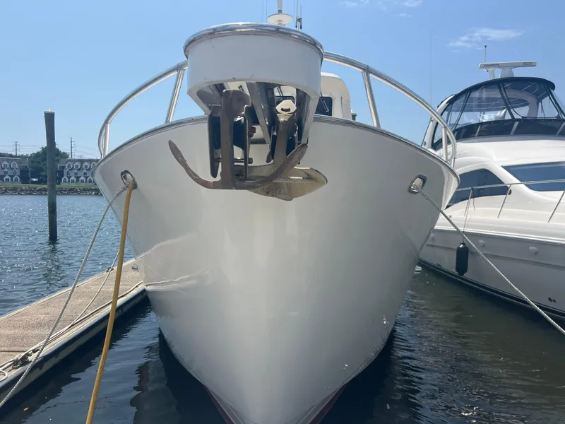 Slide: The Image of Cherubini Independence 1998 yacht docked at marina, front view with anchor visible. - 20