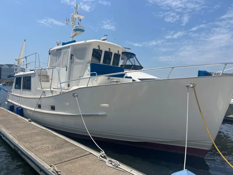 Slide: The Image of 1998 Cherubini Independence yacht docked at marina under clear blue sky. - 22