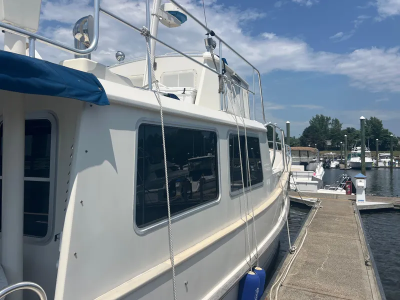 Slide: The Image of 1998 Cherubini Independence yacht docked at marina under blue sky. - 23
