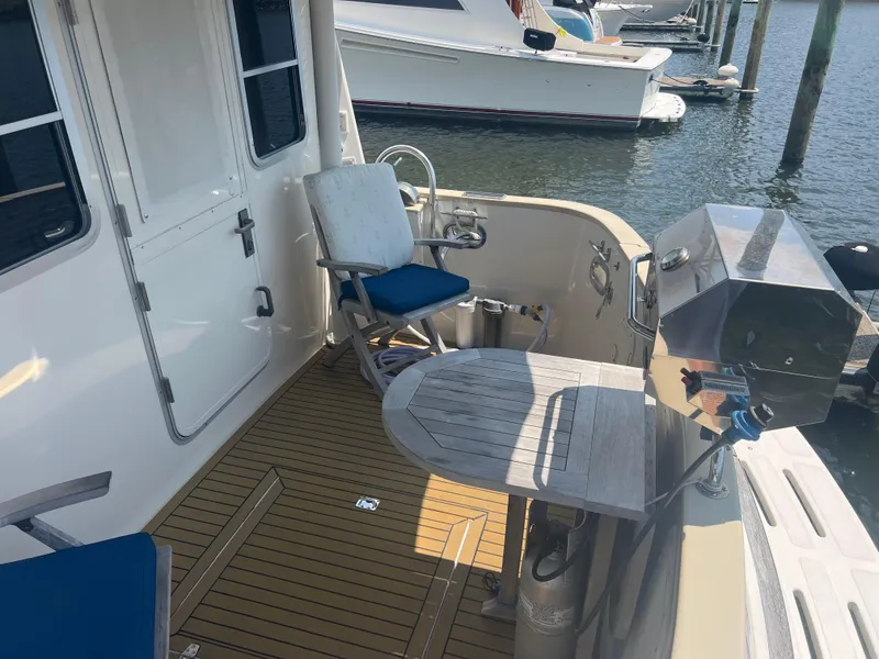 Slide: The Image of 1998 Cherubini Independence yacht deck with seating and grill at marina. - 25