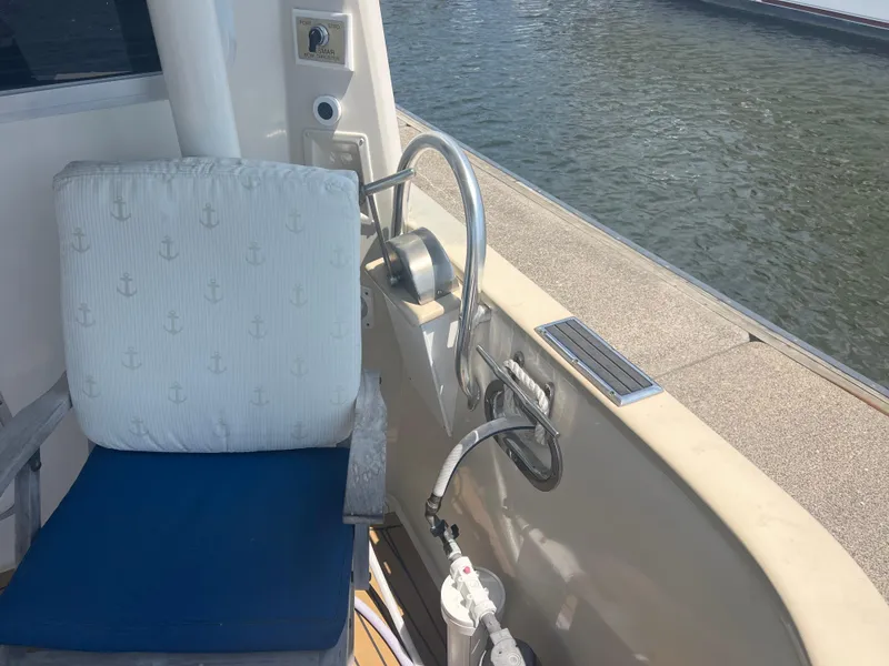 Slide: The Image of Cherubini Independence 1998 boat deck with nautical-themed chair and water view. - 29