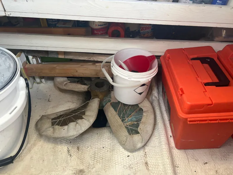 Slide: The Image of Storage area with tools, buckets, and a wrapped propeller from a 1998 Cherubini Independence. - 32