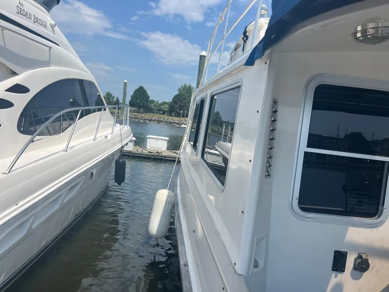 Slide: The Image of Two boats docked side by side on a sunny day, featuring a 1998 Cherubini Independence. - 34