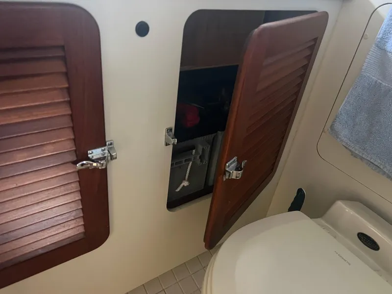 Slide: The Image of 1998 Cherubini Independence yacht bathroom with open wooden cabinet and towel. - 39