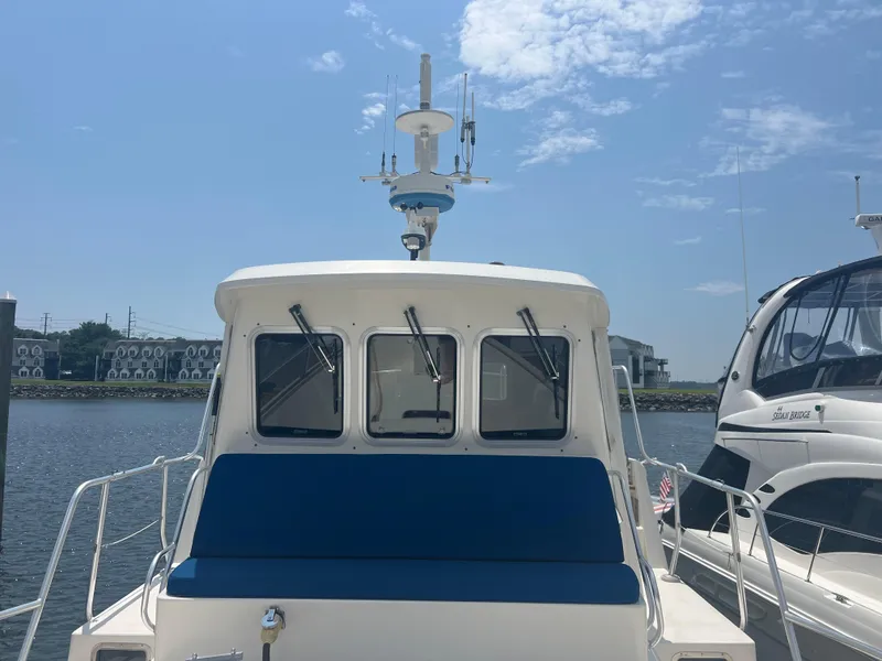 Slide: The Image of 1998 Cherubini Independence boat docked under a clear blue sky. - 4