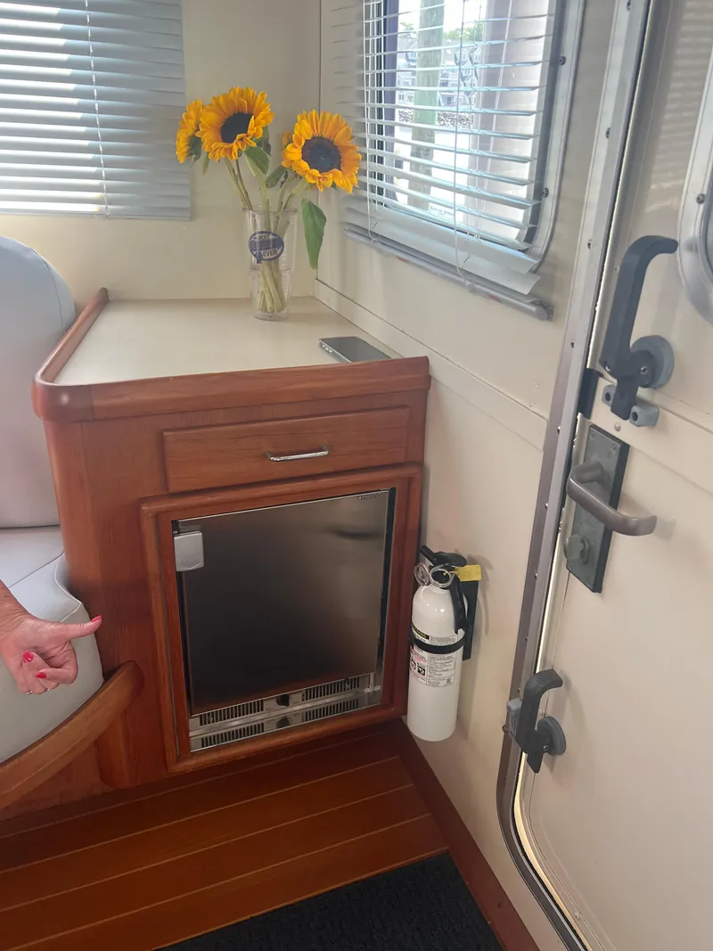 Slide: The Image of Interior of 1998 Cherubini Independence with sunflowers, wooden cabinetry, and fire extinguisher. - 43