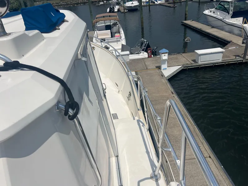 Slide: The Image of 1998 Cherubini Independence yacht docked at marina, featuring sleek design and polished railings. - 7
