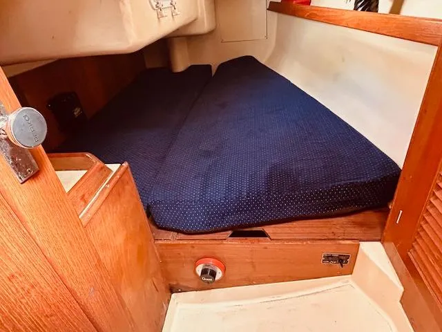 Slide: The Image of Cozy cabin interior of 1986 Pearson 28 sailboat with blue cushioned berth. - 14