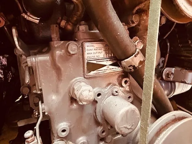 Slide: The Image of Engine close-up of a 1986 Pearson 28 sailboat, showcasing mechanical components and model details. - 24