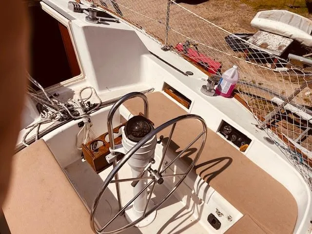 Slide: The Image of 1986 Pearson 28 sailboat cockpit with steering wheel and navigation equipment. - 3
