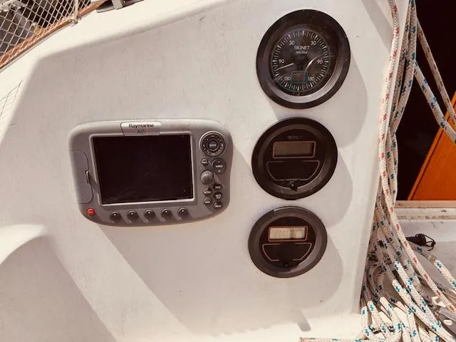 Slide: The Image of Control panel of a 1986 Pearson 28 sailboat with navigation instruments and ropes. - 5