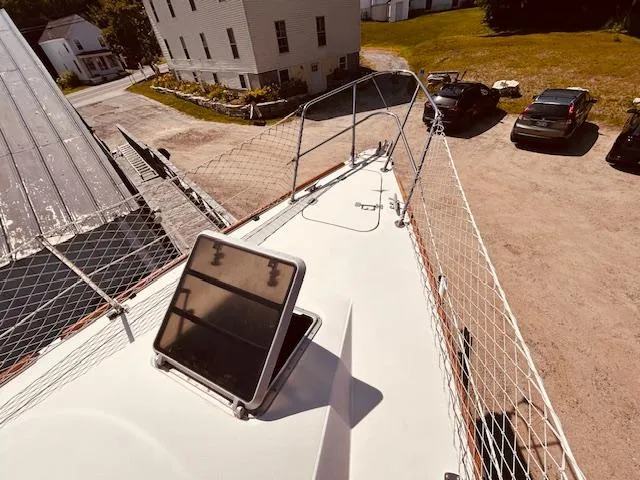 Slide: The Image of Sailboat deck of 1986 Pearson 28 with open hatch and safety netting. - 7