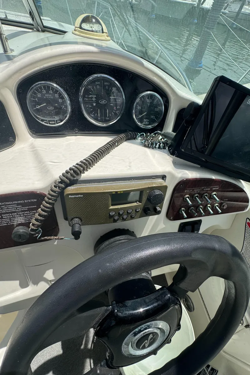 Slide: The Image of Control panel of a 2005 Sea Ray 260 Sundancer boat with gauges and navigation equipment. - 16