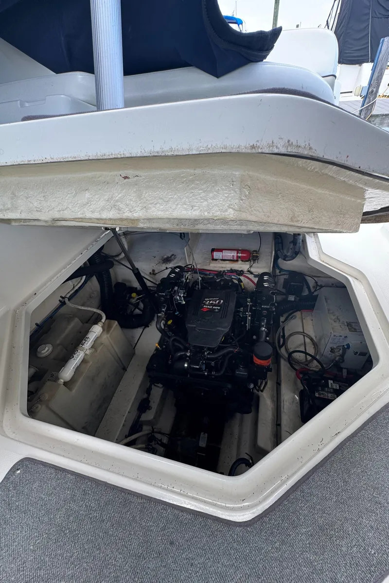 Slide: The Image of Engine compartment of a 2005 Sea Ray 260 Sundancer boat, showcasing the engine and interior components. - 17