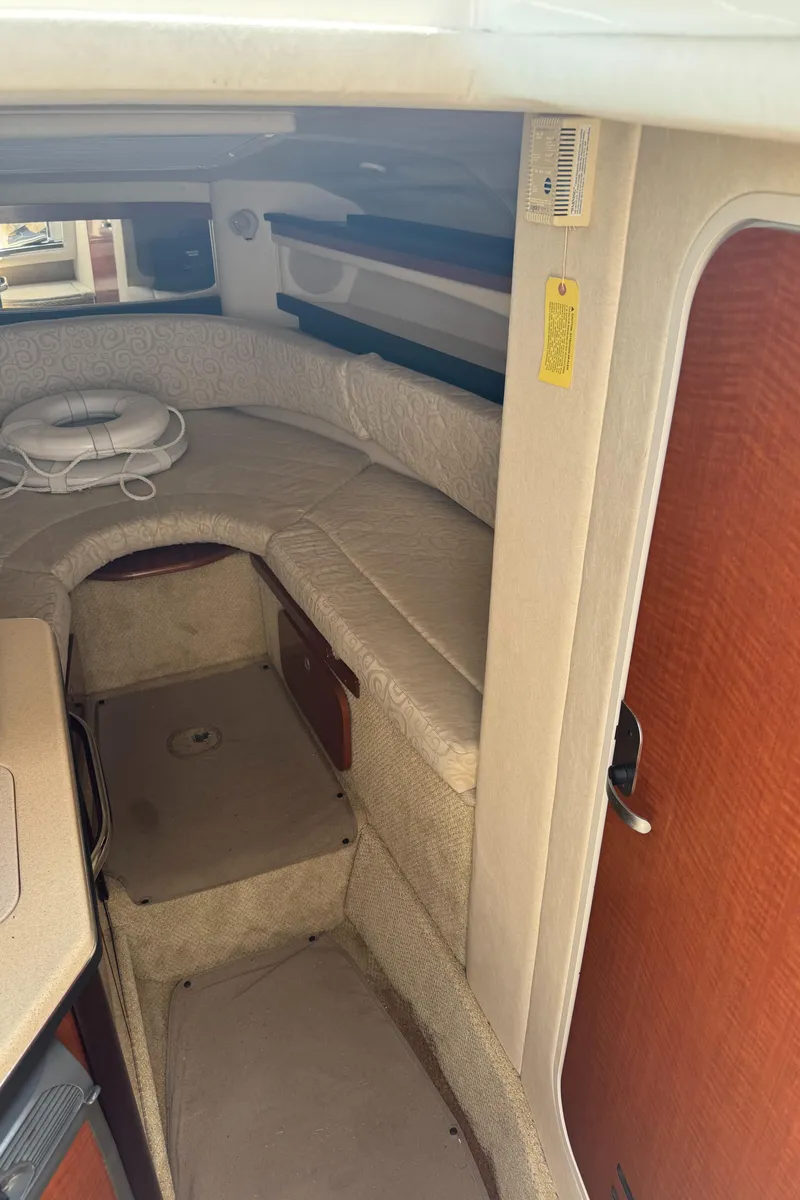 Slide: The Image of Interior cabin of 2005 Sea Ray 260 Sundancer, featuring cozy seating and storage. - 23