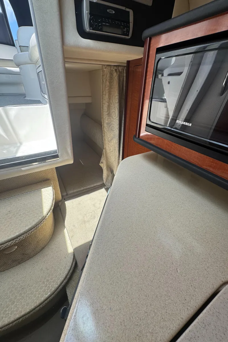 Slide: The Image of Interior of 2005 Sea Ray 260 Sundancer boat with steps and microwave. - 26