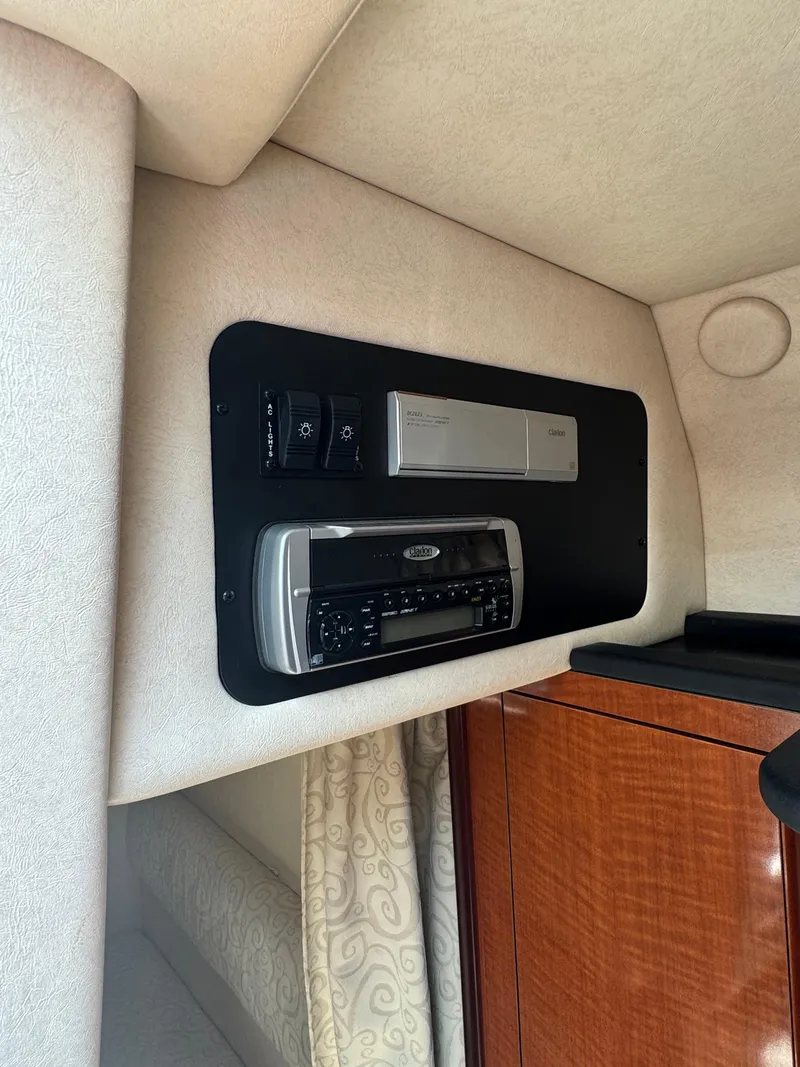 Slide: The Image of 2005 Sea Ray 260 Sundancer cabin interior with control panel and stereo system. - 28