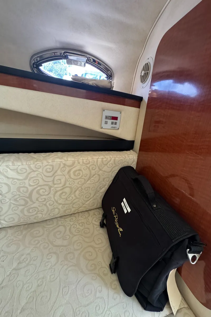 Slide: The Image of Interior cabin of 2005 Sea Ray 260 Sundancer with elegant upholstery and a Sea Ray bag. - 29