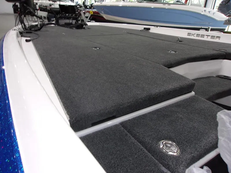 Slide: The Image of 2026 Skeeter ZXR-20 SE boat deck with gray carpet and storage compartments. - 13