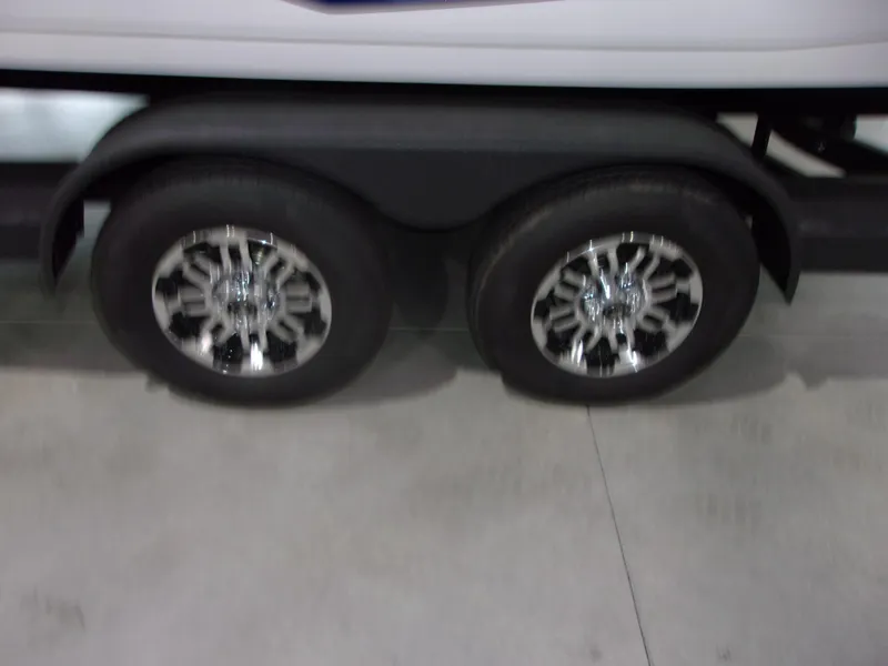 Slide: The Image of 2026 Skeeter ZXR-20 SE trailer with shiny chrome wheels on display. - 18