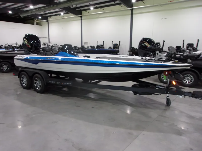 Slide: The Image of 2026 Skeeter ZXR-20 SE boat on trailer in showroom, featuring sleek design and dual engines. - 3