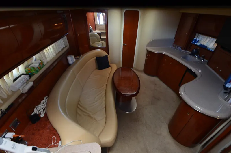 Slide: The Image of Interior of 2003 Sea Ray 420 Sundancer yacht with leather seating and wooden cabinetry. - 11