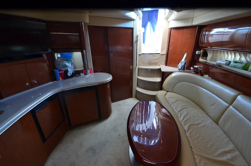 Slide: The Image of Luxurious interior of 2003 Sea Ray 420 Sundancer yacht with leather seating and wooden cabinetry. - 14