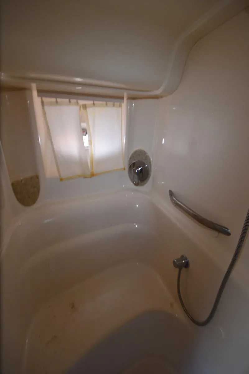 Slide: The Image of Bathroom interior of 2003 Sea Ray 420 Sundancer yacht, featuring a shower and window. - 21