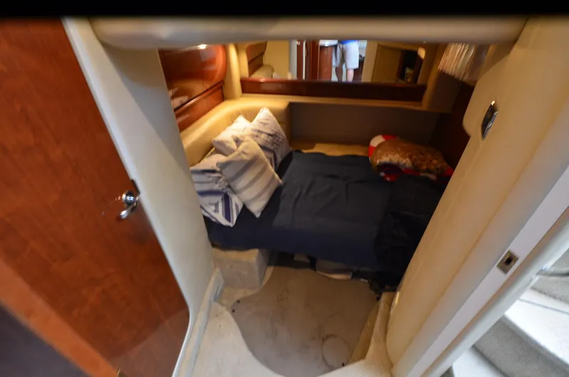 Slide: The Image of 2003 Sea Ray 420 Sundancer cabin interior with cozy bed and pillows. - 22
