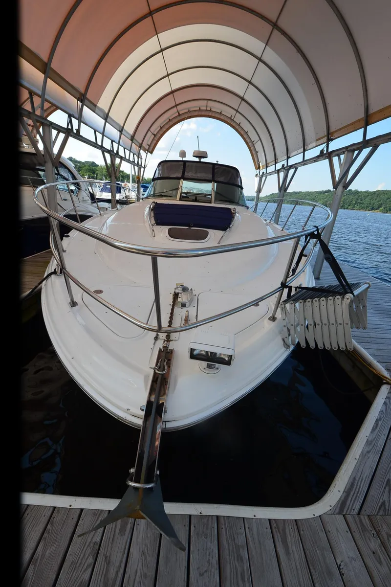 Slide: The Image of 2003 Sea Ray 420 Sundancer docked under canopy on a sunny day. - 24