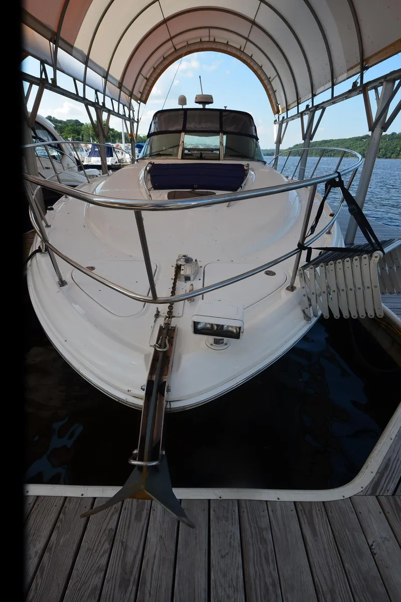 Slide: The Image of 2003 Sea Ray 420 Sundancer docked under canopy on a sunny day. - 25