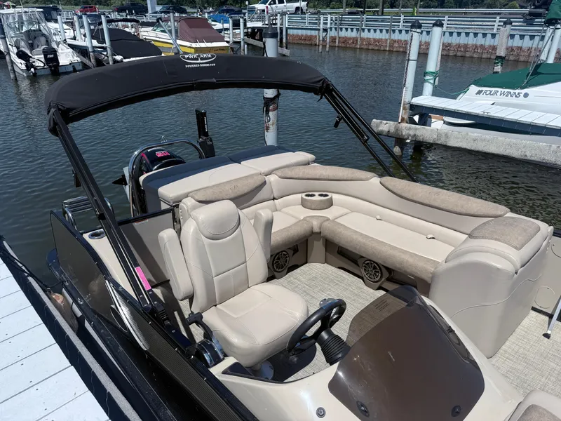 Slide: The Image of 2020 Avalon 2386 CR pontoon boat with beige seating, docked at a marina. - 3