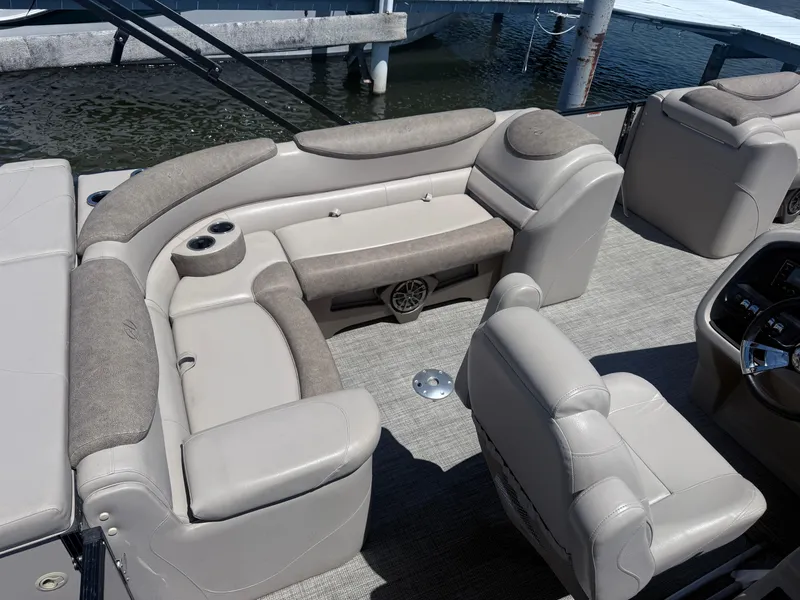 Slide: The Image of Luxurious seating on a 2020 Avalon 2386 CR pontoon boat, featuring plush upholstery and cup holders. - 5