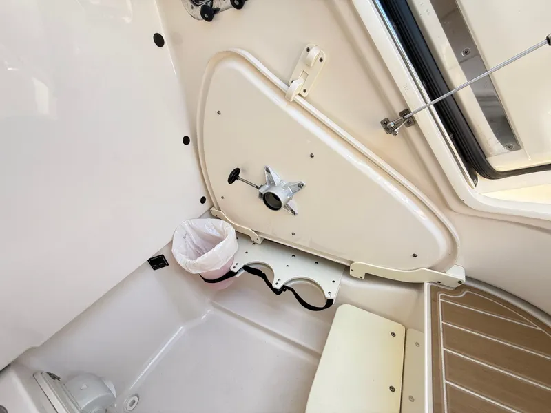 Slide: The Image of 2014 Pursuit ST 310 Sport interior cabin with storage and seating area. - 17