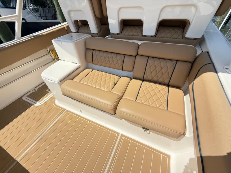 Slide: The Image of Luxurious seating on 2014 Pursuit ST 310 Sport boat with tan upholstery and diamond stitching. - 21