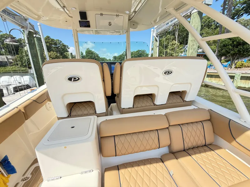 Slide: The Image of 2014 Pursuit ST 310 Sport boat interior with tan seating and sleek design. - 24
