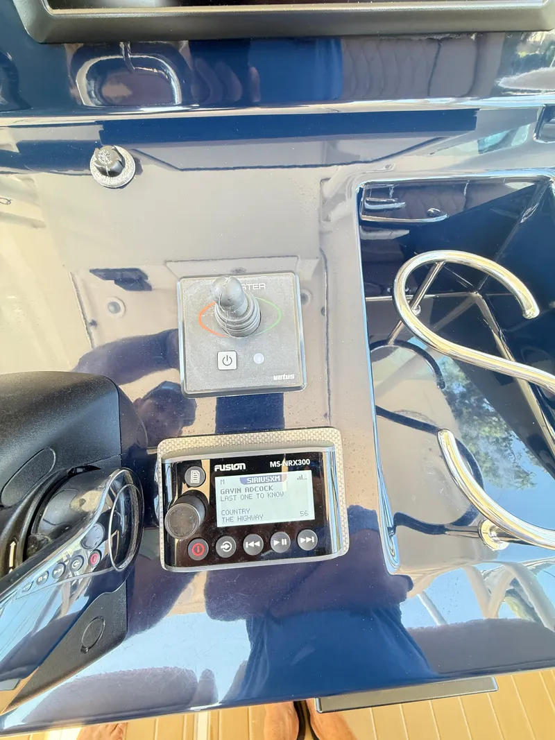 Slide: The Image of Control panel of a 2014 Pursuit ST 310 Sport boat with audio system and throttle. - 31