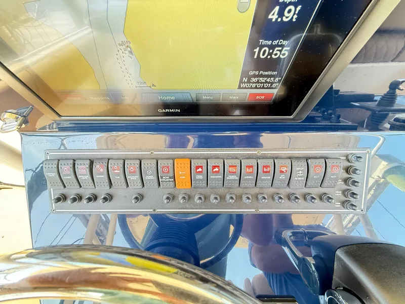 Slide: The Image of Control panel of a 2014 Pursuit ST 310 Sport boat with Garmin navigation display. - 33
