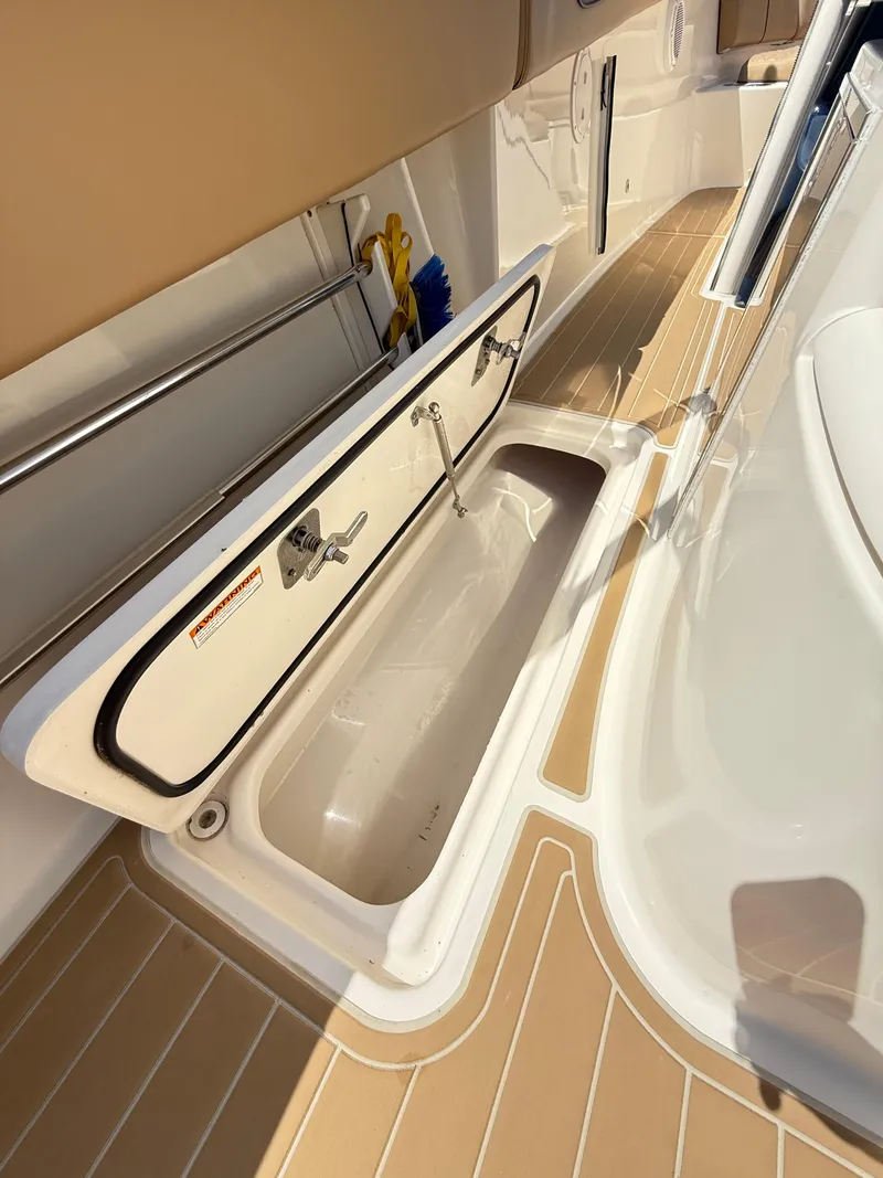 Slide: The Image of Open storage compartment on 2014 Pursuit ST 310 Sport boat deck. - 42