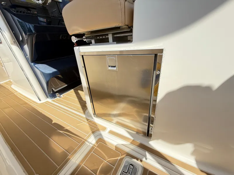 Slide: The Image of 2014 Pursuit ST 310 Sport boat interior with stainless steel storage compartment. - 43
