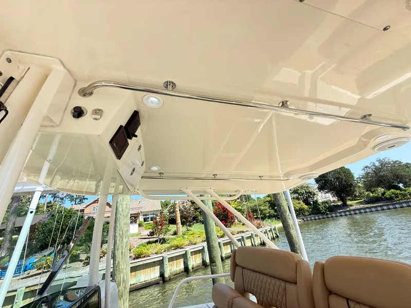 Slide: The Image of 2014 Pursuit ST 310 Sport boat interior with seating and overhead view. - 51