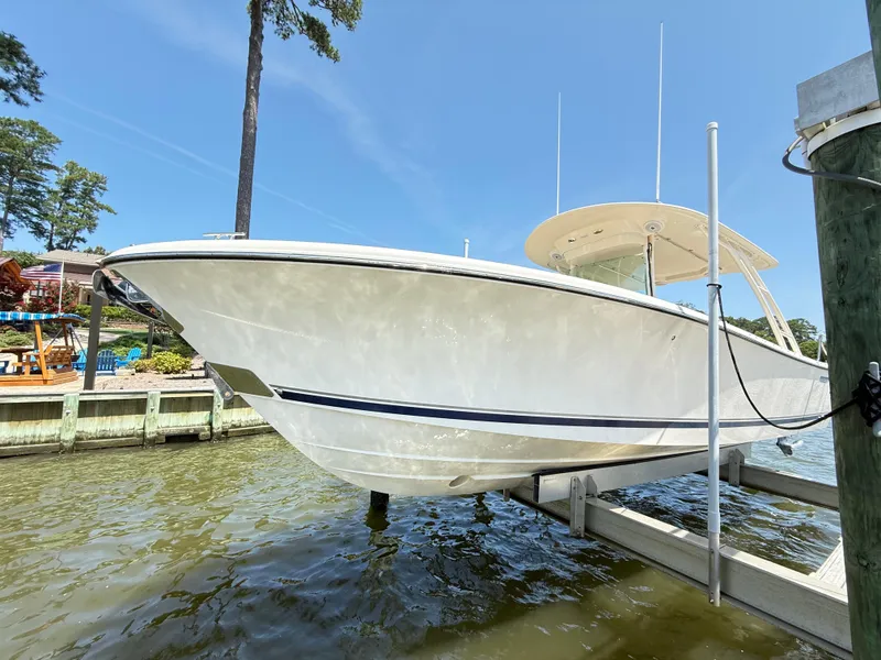 Slide: The Image of 2014 Pursuit ST 310 Sport boat docked on a sunny day. - 9