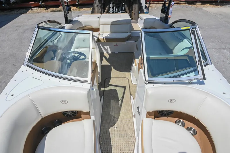 Slide: The Image of 2015 Cobalt 220 boat interior with white seating and open cockpit design. - 10