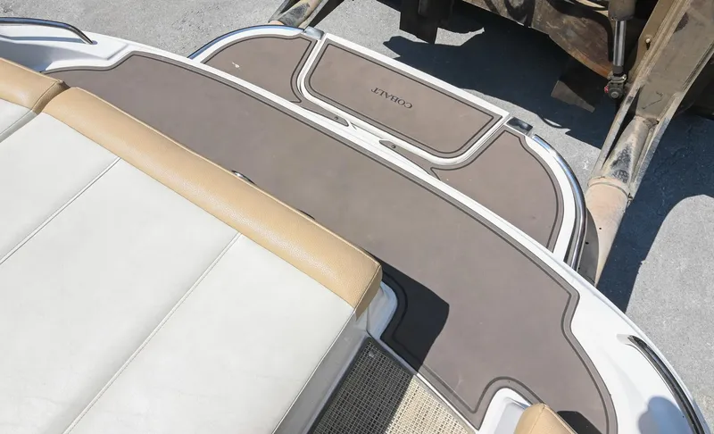 Slide: The Image of 2015 Cobalt 220 boat interior with tan and white seating, viewed from above. - 11