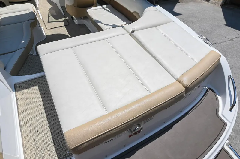 Slide: The Image of 2015 Cobalt 220 boat interior with beige and white seating. - 12