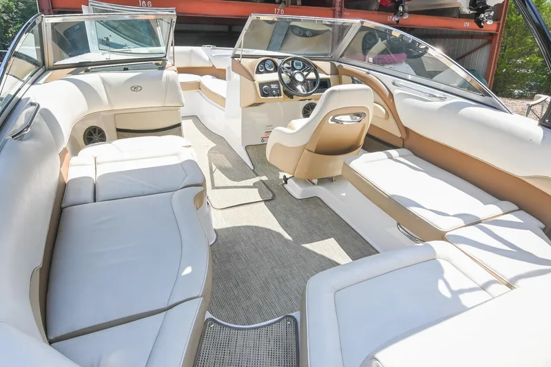 Slide: The Image of Interior of a 2015 Cobalt 220 boat with luxurious white and tan seating. - 14