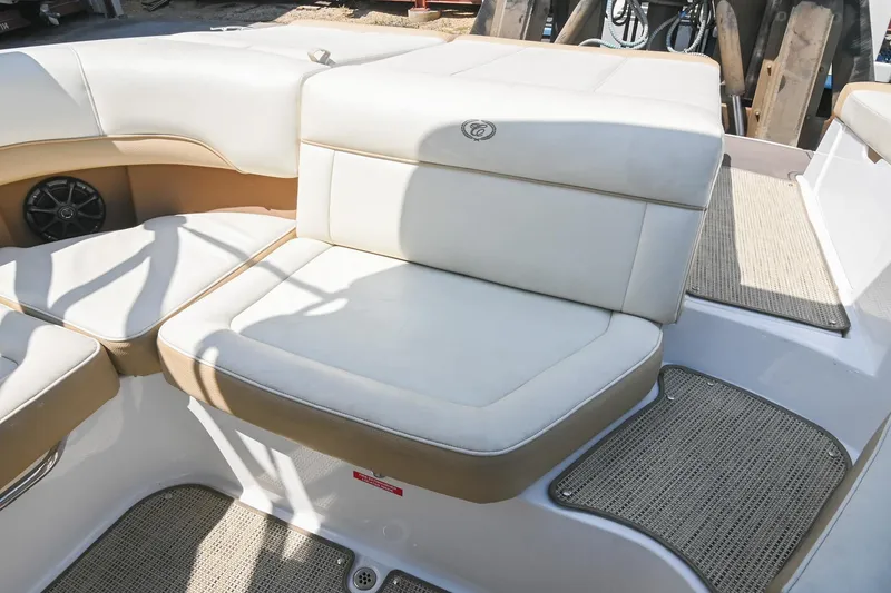 Slide: The Image of 2015 Cobalt 220 boat interior with beige seating and speaker. - 15